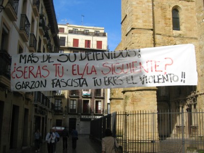 Translation: "More than 30 Detainees! Are you next? Garzon (big wig Spainsh judge) fascist, you are the violent!"